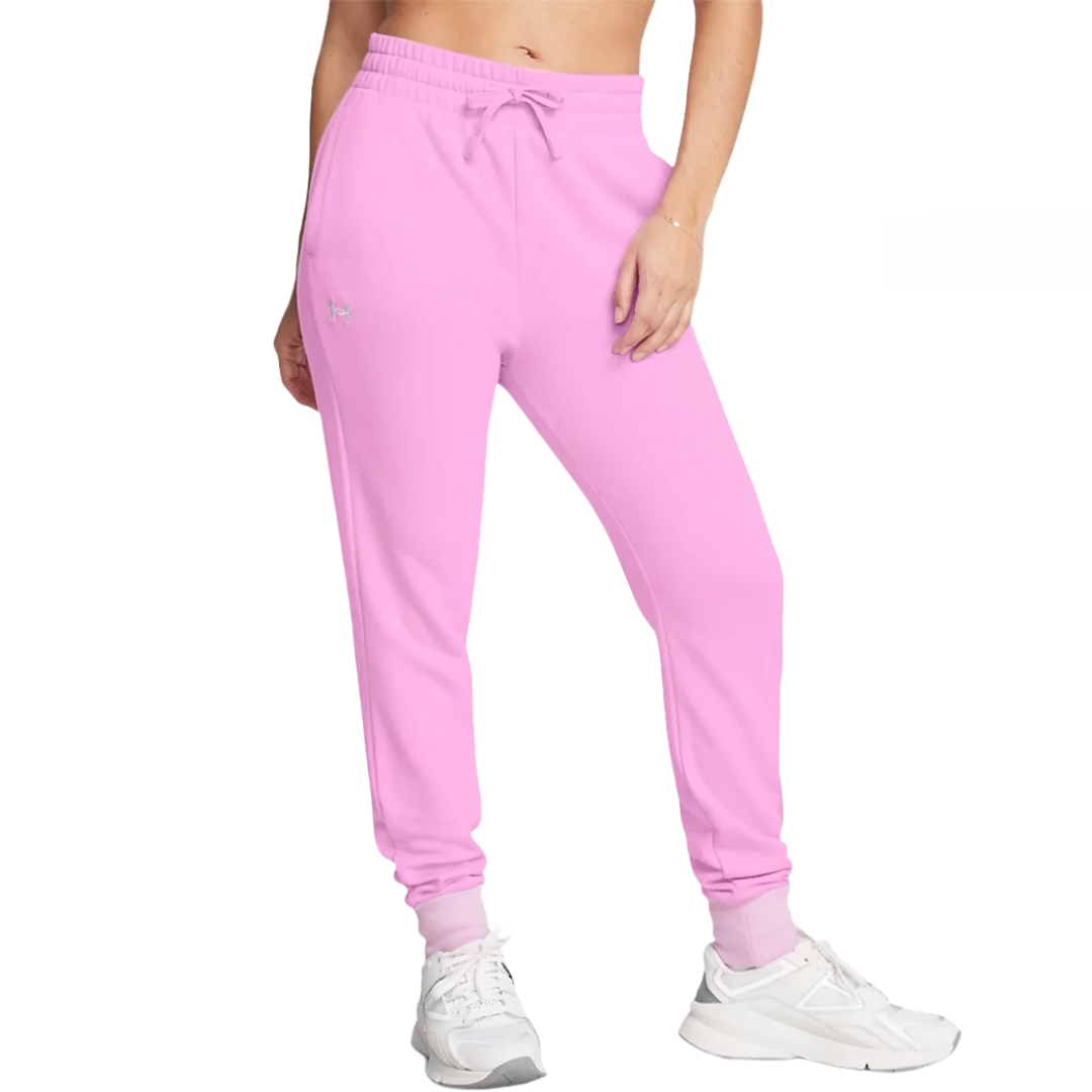 Under Armour Rival Fleece Joggers are pink jogger pants featuring an elastic waistband with drawstring, side pockets, and cuffed ankles, paired with white sneakers.