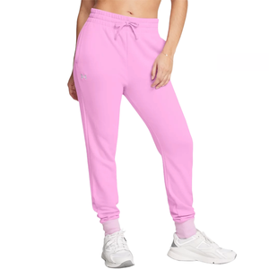 Under Armour Rival Fleece Joggers are pink jogger pants featuring an elastic waistband with drawstring, side pockets, and cuffed ankles, paired with white sneakers.