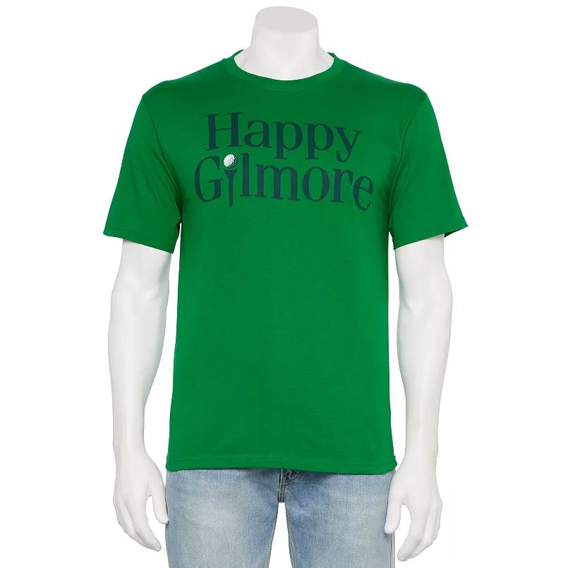 Green t-shirt with \“Happy Gilmore\“ printed on the front, featuring a golf ball integrated into the design, paired with light blue jeans on a mannequin.