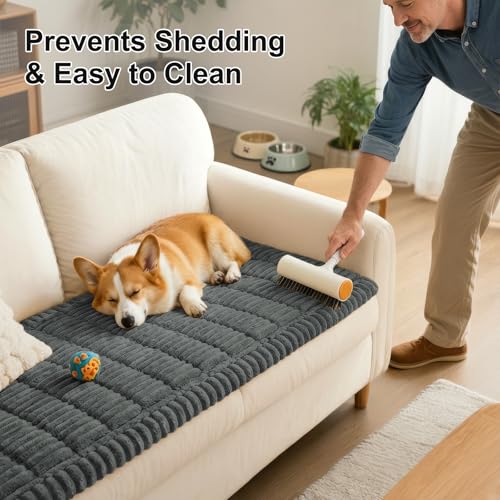 A person uses a lint roller on a gray anti-shedding sofa cover while a dog rests on it, highlighting the cover's easy-to-clean feature.