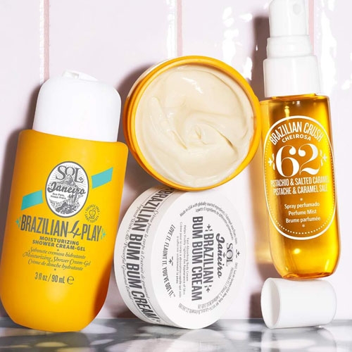 Sol de Janeiro skin care items including a shower cream-gel, body cream, and a spray perfume with a pistachio and salted caramel scent.