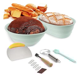 7-piece sourdough bread baking kit includes two round proofing baskets, dough scraper with orange handle, stainless steel dough whisk, scoring tool with wooden handle, silicone brush, five extra blades, and a small brown square tool.