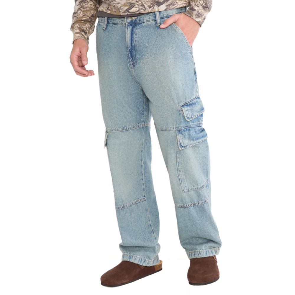 Light blue denim cargo pants with multiple pockets, paired with brown slip-on shoes and a camouflage-patterned shirt.