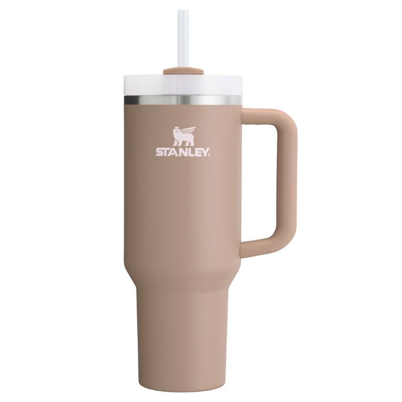 A beige Stanley Quencher Tumbler with a 40oz capacity features a handle, a screw-on lid, and a straw. It is designed for both hot and cold beverages.