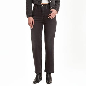 Levi's Ribcage Straight Ankle Jeans feature a high waist, straight leg fit, and ankle-length cut. Shown here in dark denim, they pair well with black ankle boots.