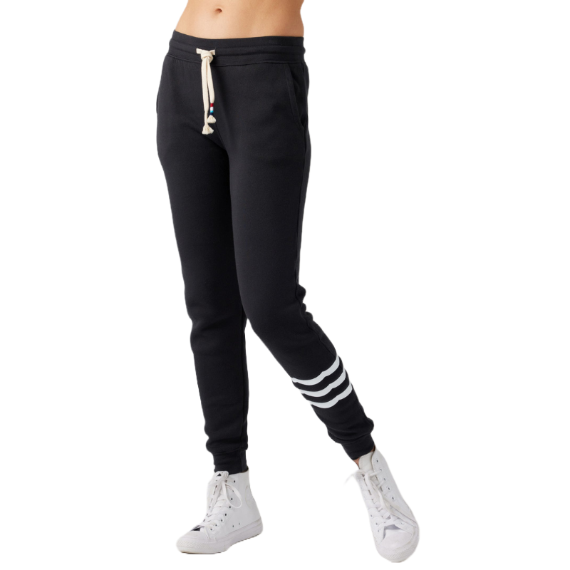 Black jogger pants with white drawstring and side pockets, featuring three white stripes on one leg, paired with white high-top sneakers.