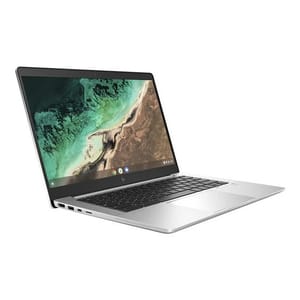 A silver HP Chromebook laptop with a thin design and a display showing a desert and ocean landscape. It features a keyboard and multiple ports on the left side.