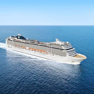 A large white cruise ship sailing on the ocean.