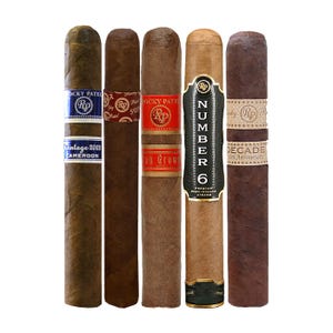 Five Rocky Patel cigars are displayed side by side, each with different bands and colors of wrappers, indicating a variety of blends and editions.