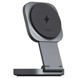 A silver and black AUKEY wireless charging stand with a foldable design and a lightning bolt symbol, suitable for propping up devices while charging.