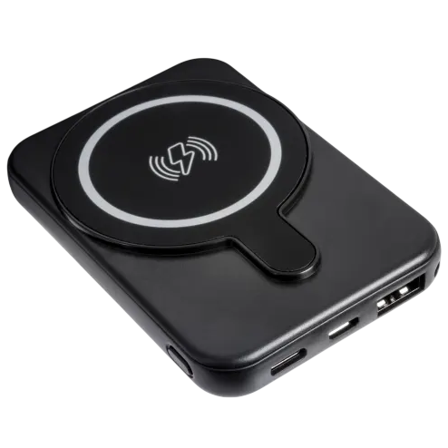 A black wireless power bank with a circular charging pad and multiple input/output ports for charging devices.