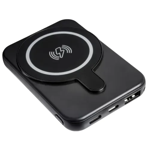A black wireless power bank with a circular charging pad and multiple input/output ports for charging devices.