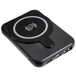 A black wireless power bank with a circular charging pad and multiple input/output ports for charging devices.