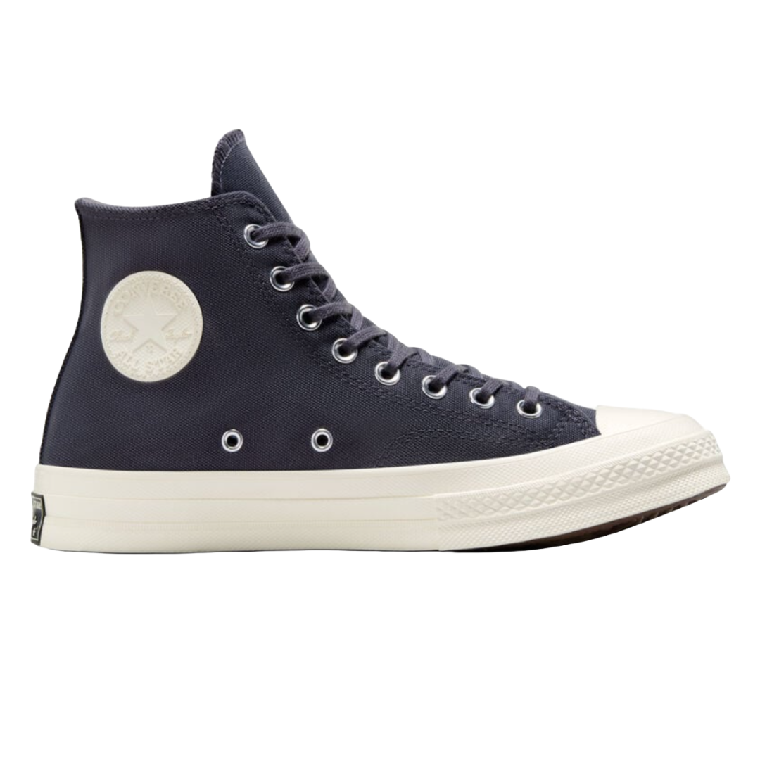 A dark blue high-top sneaker with a white rubber sole and a circular logo patch on the side.