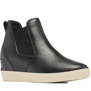 Black leather ankle boot with a wedge heel and beige rubber outsole, featuring side elastic panels for easy slip-on.