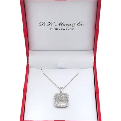 A silver necklace with a rectangular pendant featuring intricate diamond detailing is displayed in an open red jewelry box labeled \“R.H. Macy & Co. Fine Jewelry.\“
