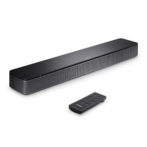 A black soundbar with a mesh grille and a small remote control.