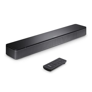 A black soundbar with a mesh grille and a small remote control.