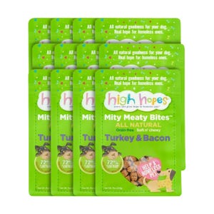 Nine packs of High Hopes Mity Meaty Bites dog treats in Turkey & Bacon flavor, grain-free and chewy, in green packaging.