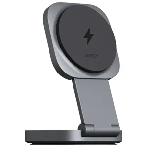 A grey Aukey wireless charging stand with a foldable design and a lightning bolt symbol on the charging pad.