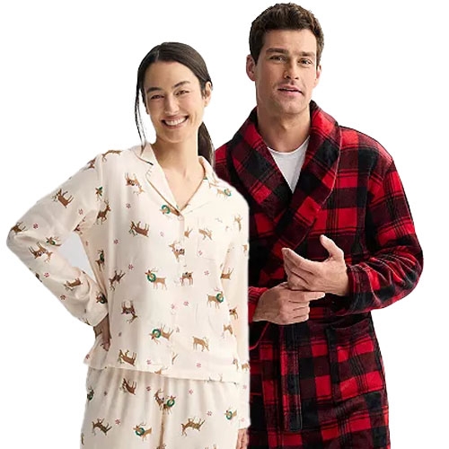 A woman in festive reindeer pajamas and a man in a red and black plaid robe, both designed for cozy wear.