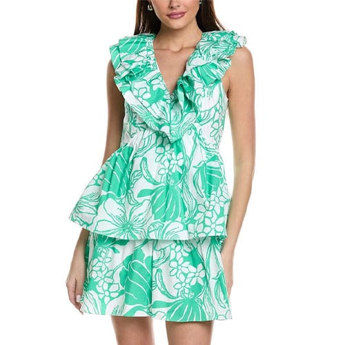 A sleeveless mini dress featuring a green and white floral pattern, designed with a ruffled V-neckline and a peplum waist for added flair.