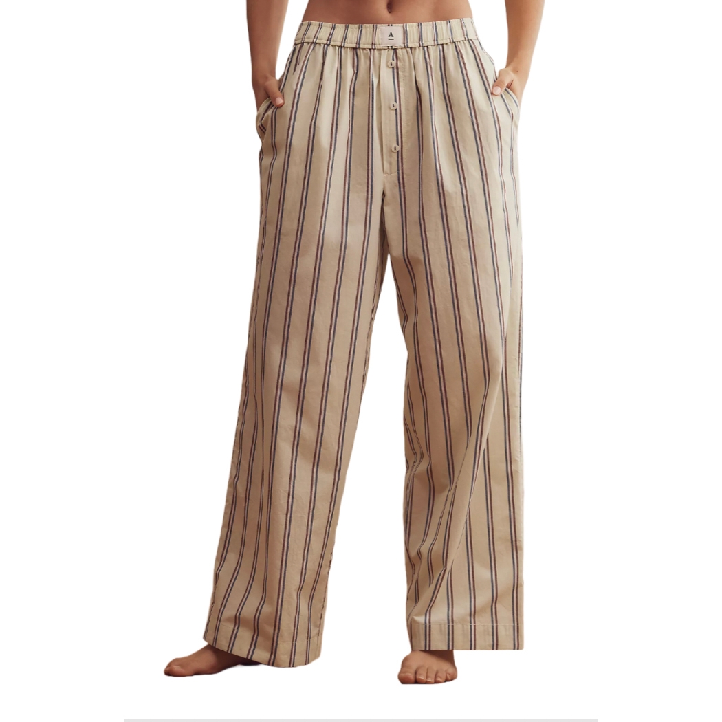 Loose-fitting, wide-leg pants with vertical stripes, featuring an elastic waistband and button details, including side pockets for added functionality.