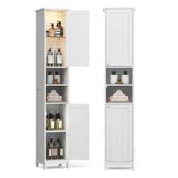 Two tall white storage cabinets, each with a combination of closed compartments and open shelves, storing bottles, towels, and small items.