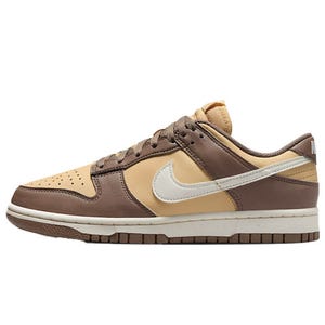 A Nike Dunk Low sneaker in shades of brown and beige, featuring a white swoosh and a brown outsole.