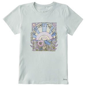 A pastel-colored \“Life is Good\“ tee featuring a design with a sun, flowers, and the phrase \“Here Comes the Sun\“ in retro-style lettering.