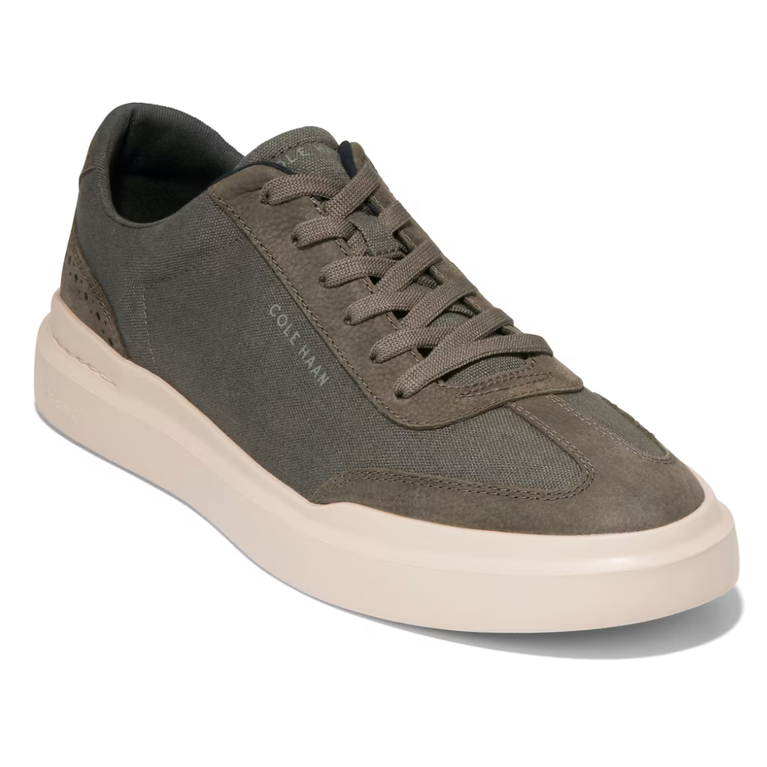 Olive green sneaker with beige sole and lace-up design.