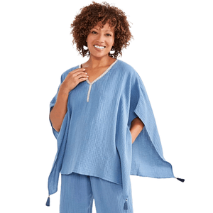 Lightweight blue gauze poncho featuring an embellished V-neckline and wide, loose-fitting sleeves with tasseled corners, paired with matching pants.