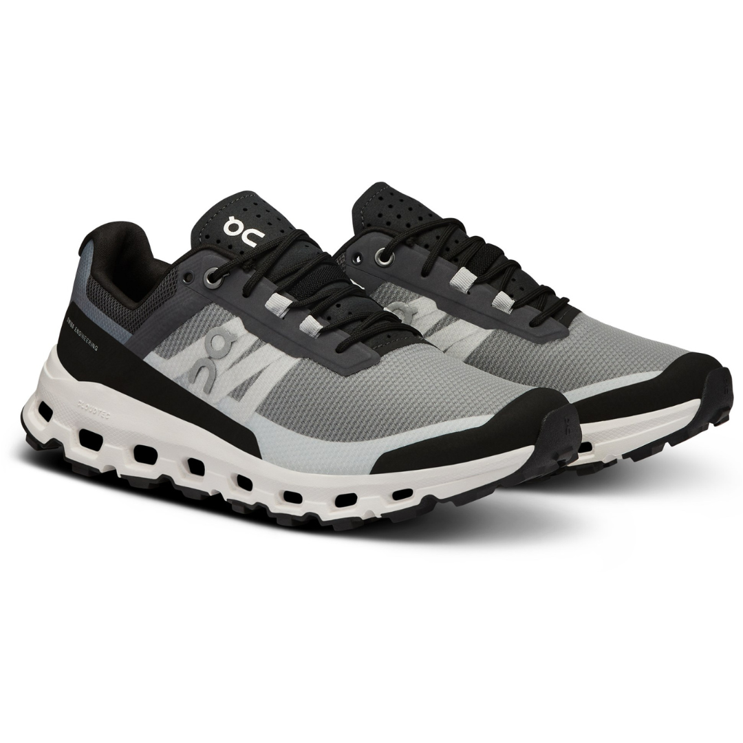A pair of grey and black running shoes with a white sole and black laces.