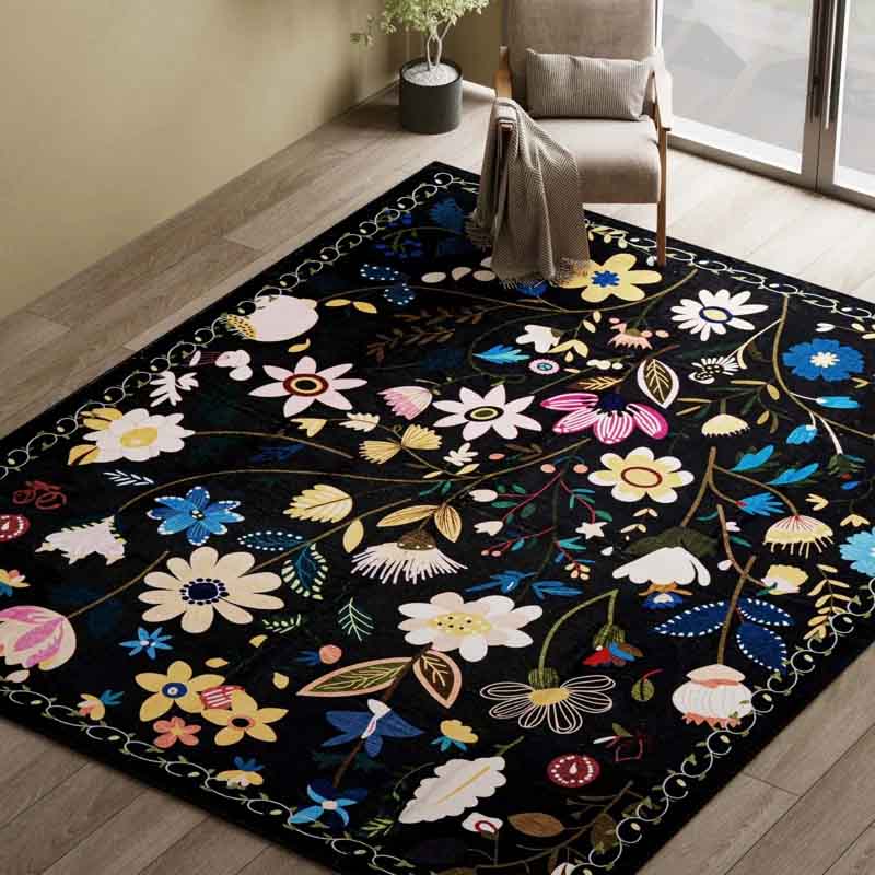 A 5' x 8' modern floral area rug with a black background adorned with colorful flower and leaf patterns in shades of blue, pink, yellow, and white, featuring a decorative border.