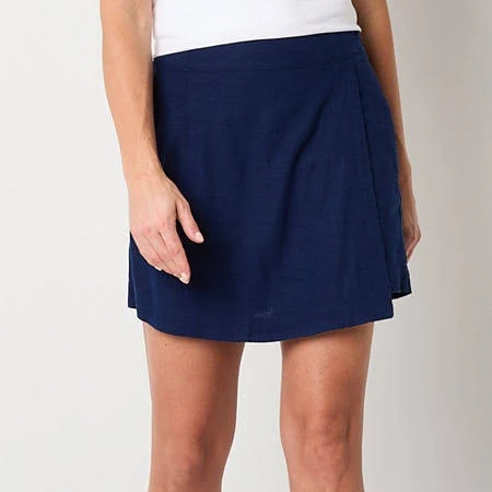 A navy blue skort with a flat front design and side pockets, worn by a person.