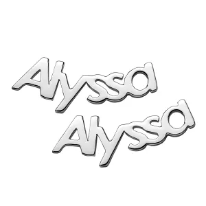 Two silver metallic badges with the name \“Alyssa\“ written in a stylized font.