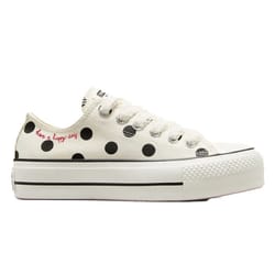 White low-top Converse All Star shoes with black polka dots, a platform sole, black stripe detailing, and red text that reads \“have a happy day\“ on the side.