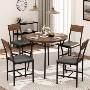 Dining set with a round wooden table and four chairs featuring black seats and wooden backrests, accompanied by tableware, a small serving cart, pendant lights, and a wall clock, all set on a textured rug.