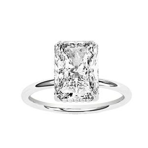 A ring featuring a large, rectangular radiant-cut diamond set on a simple white gold or platinum band.