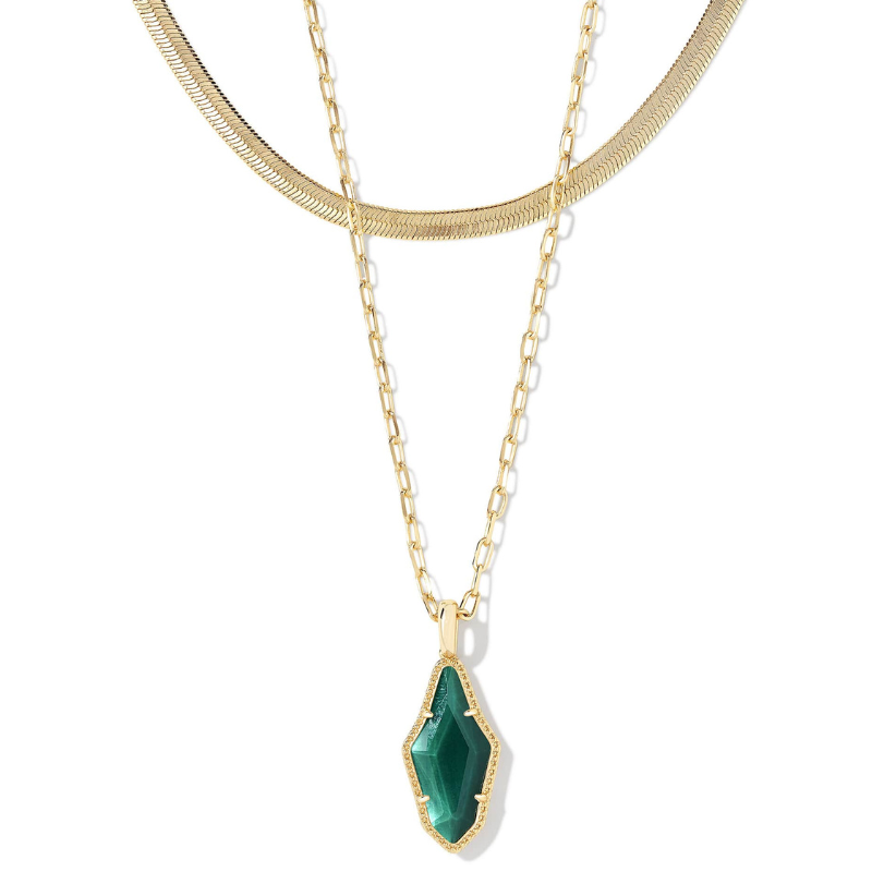 The Evelyn Gold Multi Strand Necklace features two gold chains: one is a delicate snake chain, and the other has a larger link design, with a green geometric gemstone pendant outlined in gold, combining elegance and modern style.