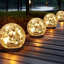 Glowing spherical lights line a pathway, featuring a woven design with warm, starry illumination inside.