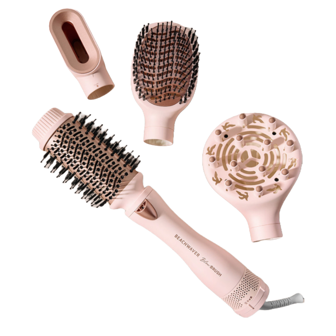 The 4pc Beachwaver Blow Brush set includes a pink handle with interchangeable attachments: a round brush, paddle brush, diffuser, and concentrator nozzle for versatile hair styling.