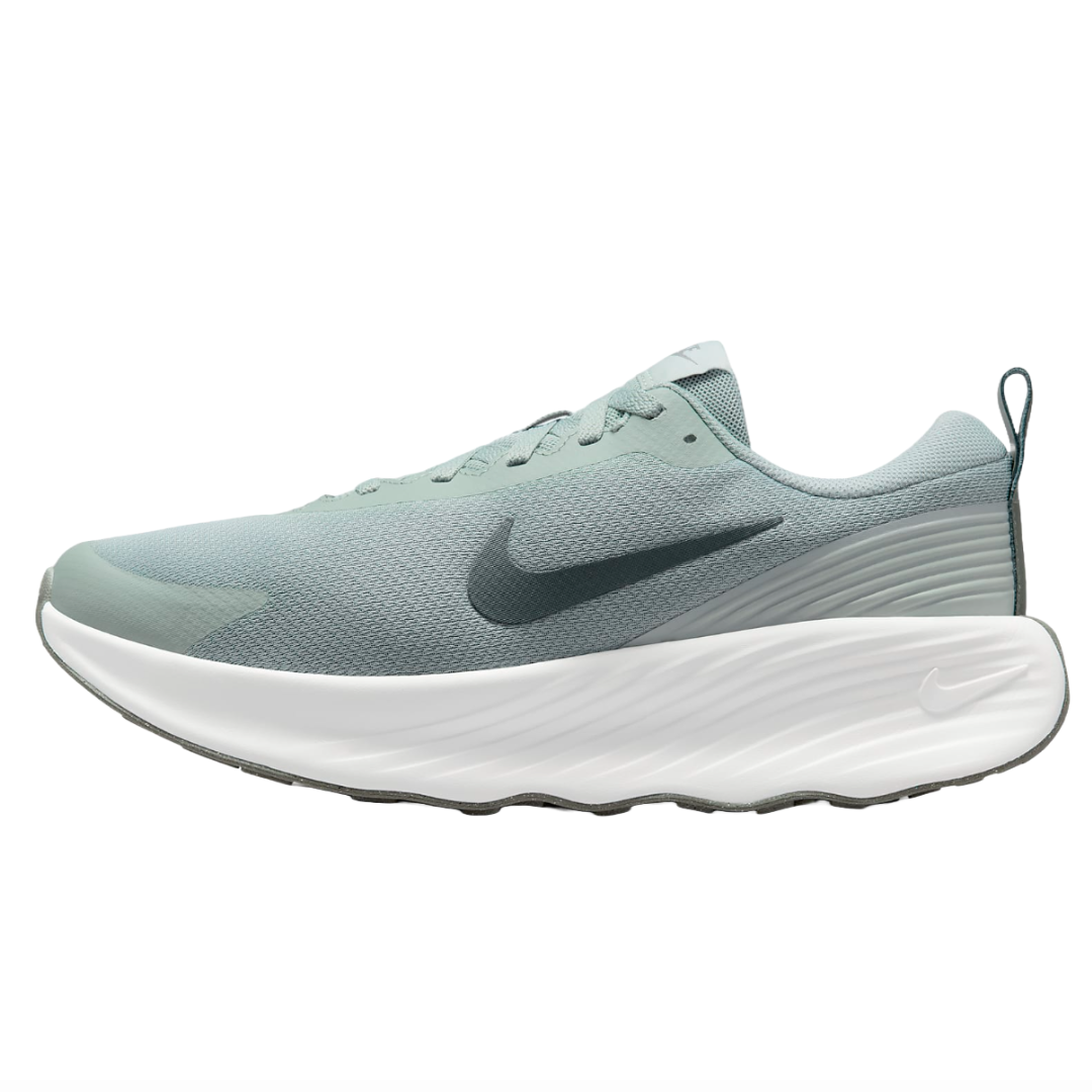 Nike running shoe with a light green mesh upper, white textured sole, and a dark Nike swoosh logo.