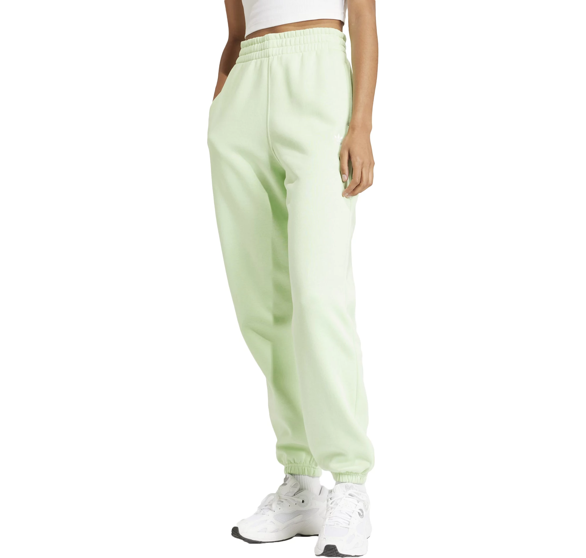 A person is wearing pastel green sweatpants with elastic cuffs and white sneakers.