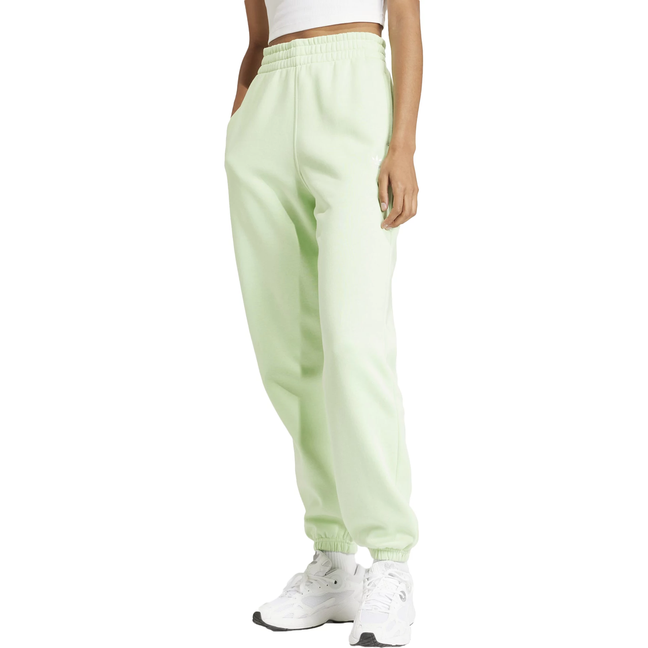 A person is wearing pastel green sweatpants with elastic cuffs and white sneakers.