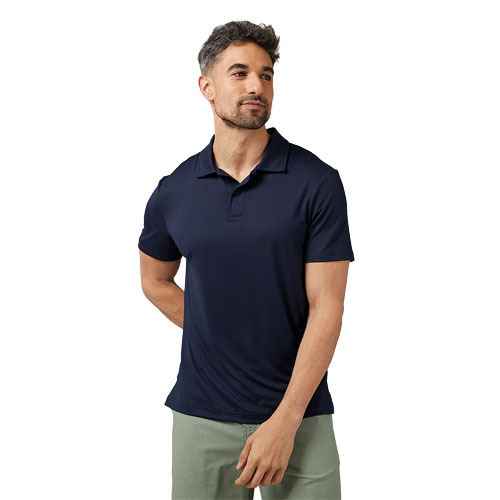 A man is wearing a navy blue polo shirt paired with light green pants.