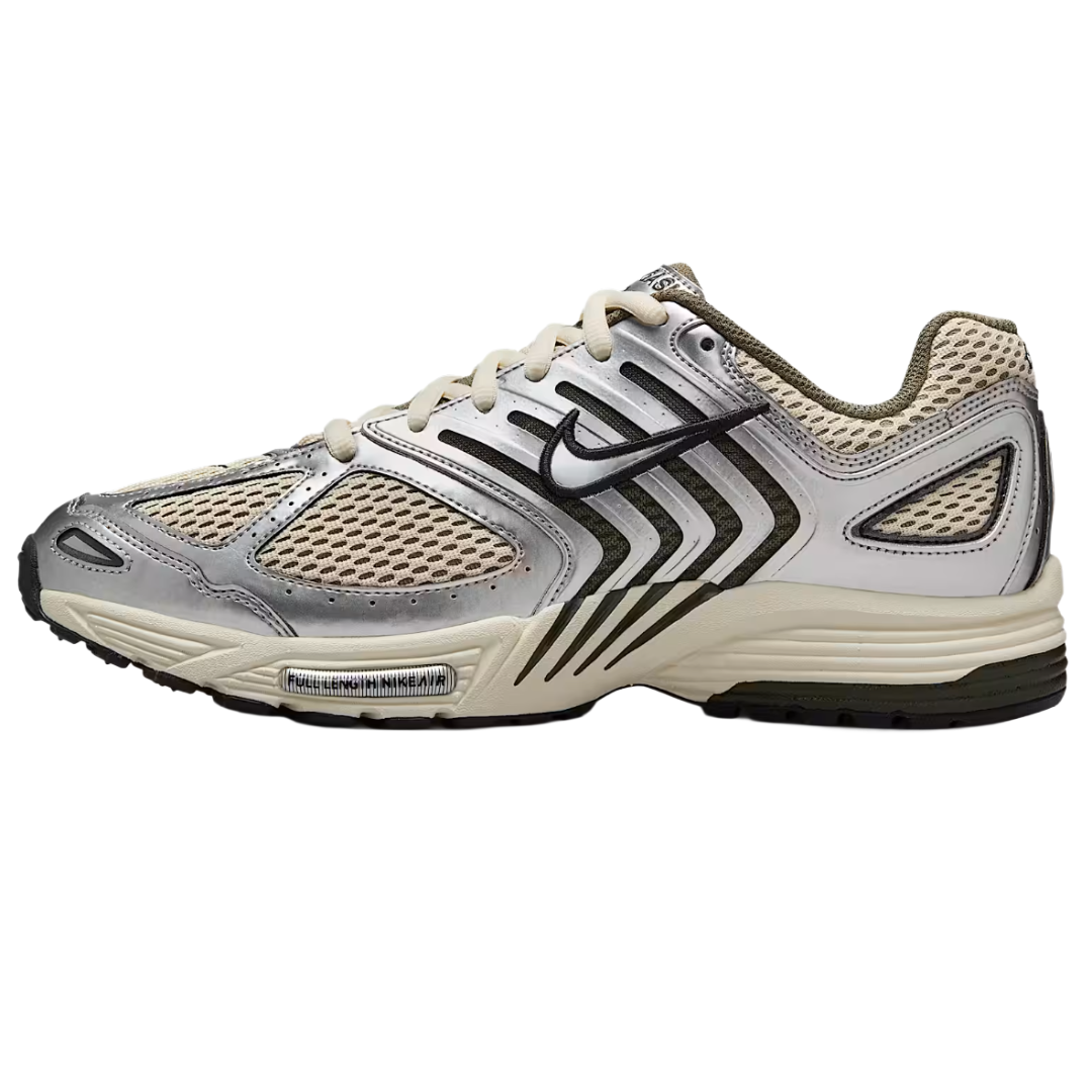 A running shoe with a beige mesh upper, silver overlays, black zigzag patterns, and a black Nike swoosh. It features a textured outsole for traction and a cushioned midsole.