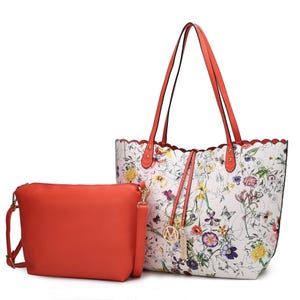 A two-piece set featuring a large tote with a floral pattern and scalloped edges, paired with a solid red pouch. The tote includes red handles and a decorative charm.
