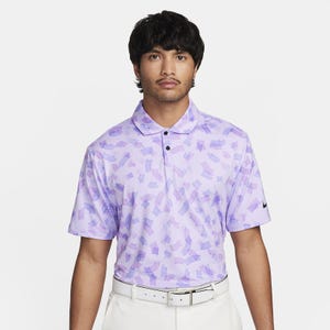 A man wearing a purple and white patterned polo shirt with a collar and a small logo on the chest.