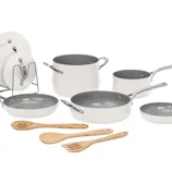 Cookware set with off-white and gray non-stick pots and pans, including a stockpot, two saucepans, two frying pans, a sauté pan, four lids, and three wooden utensils.